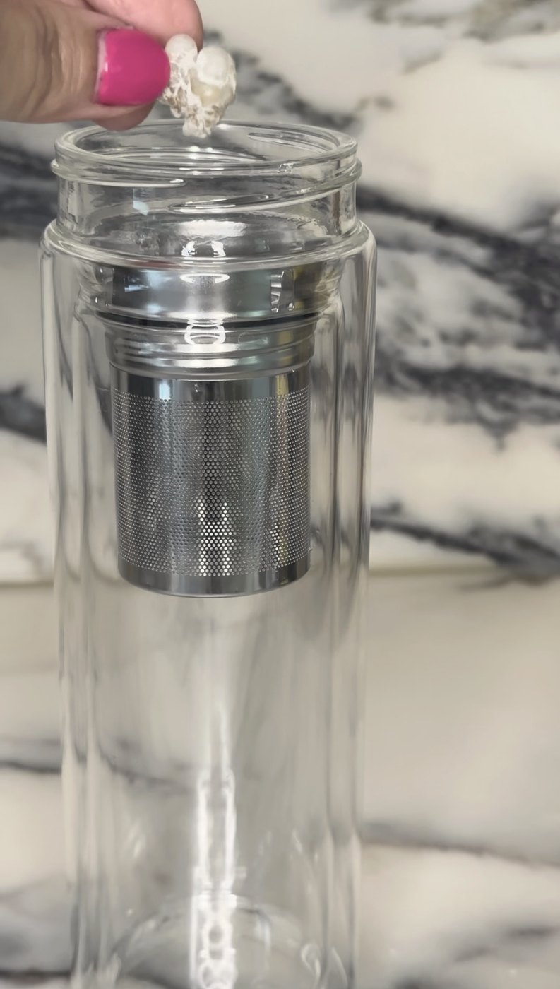 a piece of frankincense resin dropped into a glass infuser bottle