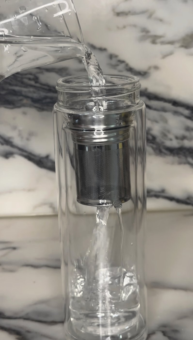 water poured over frankincense resin in a glass bottle